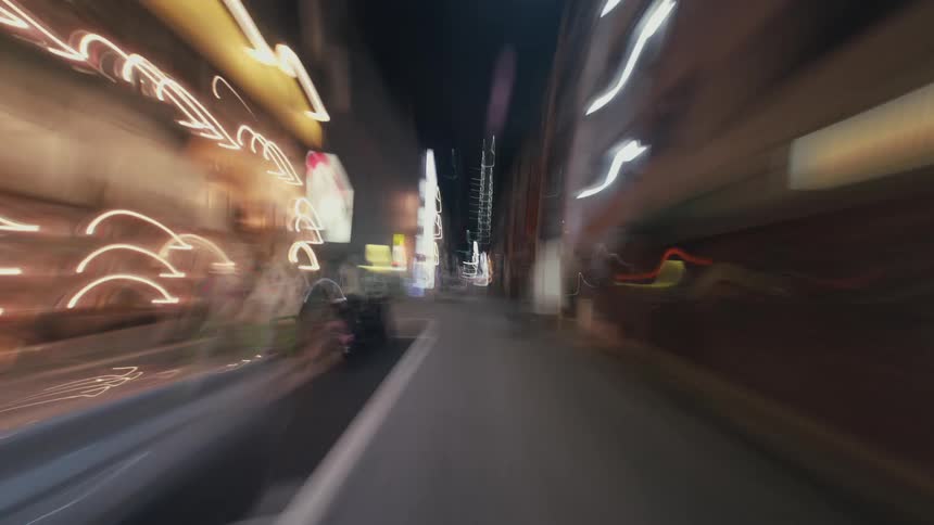 A disorienting first-person hyper-lapse speeds through the vibrant, neon-lit streets of a city at night