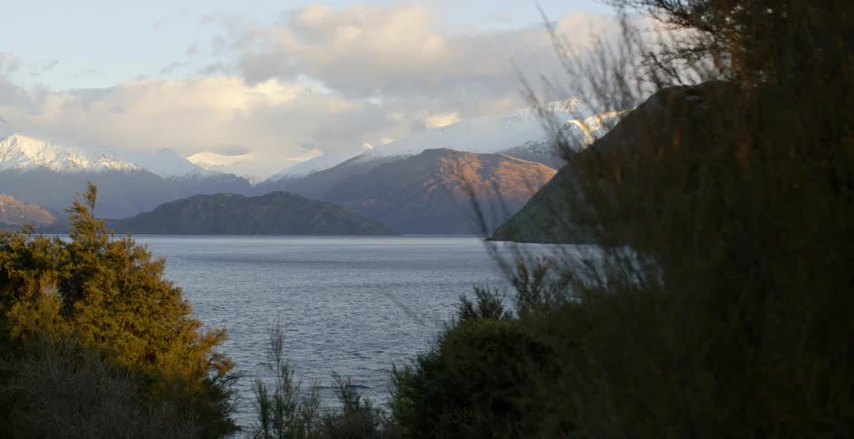 Lake flowing with mountains in the background