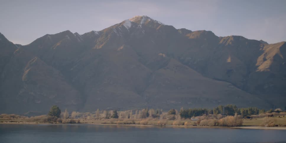 A large lake sits before this mountain