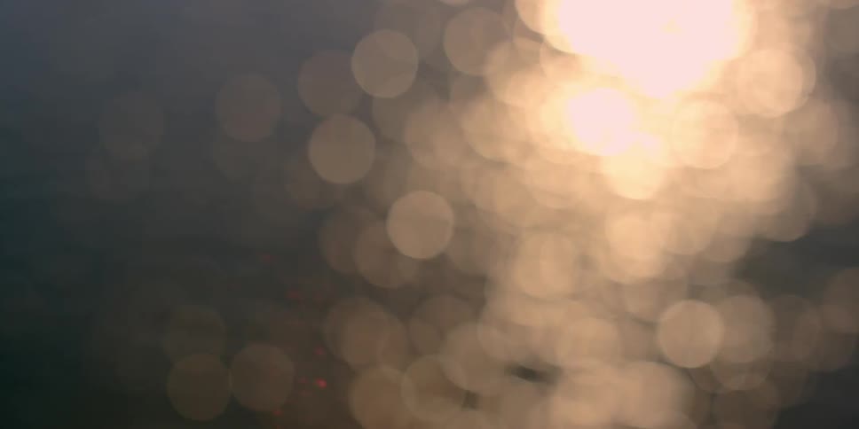 Close up of sun shining on water