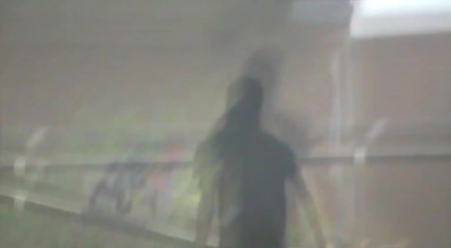 Dreamy vintage-style footage captures a person walking away from the camera while carrying a skateboard