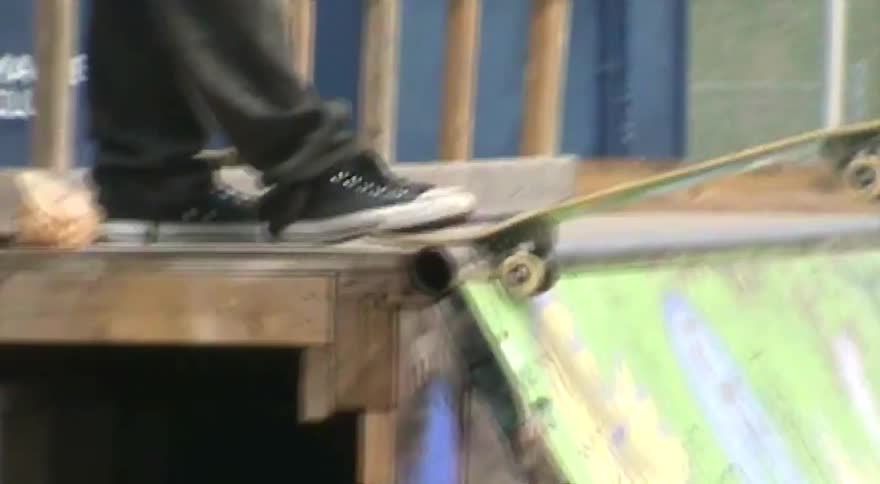 A slow zoom out reveals a skateboarder standing at the top of a homemade ramp, ready to drop in