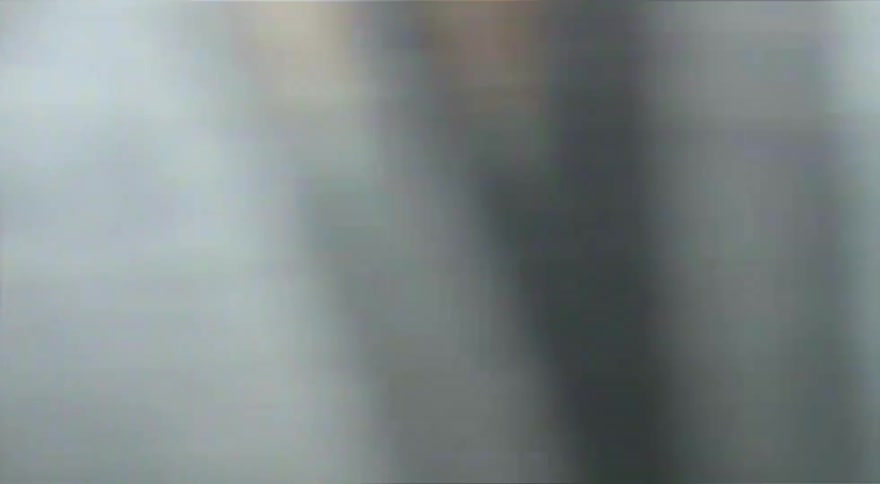 A gritty, vintage-style close-up of a skateboarder grinding a rail at a skatepark