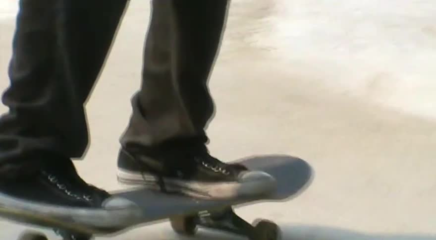 Dreamy, vintage-style footage follows a skateboarder as they cruise around a graffiti-covered concrete skate park