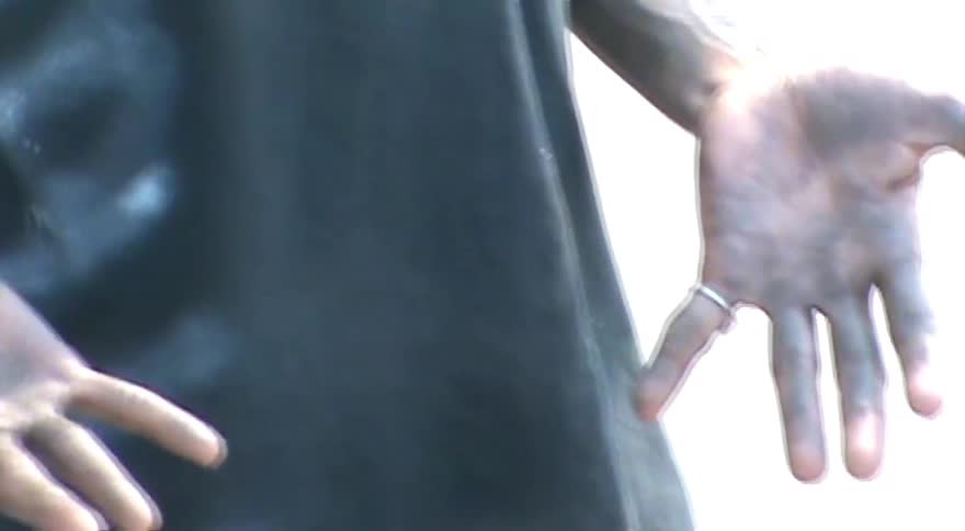 A stylistic close-up with an echo effect shows a person's dirty hands as they move them slowly in an urban skatepark