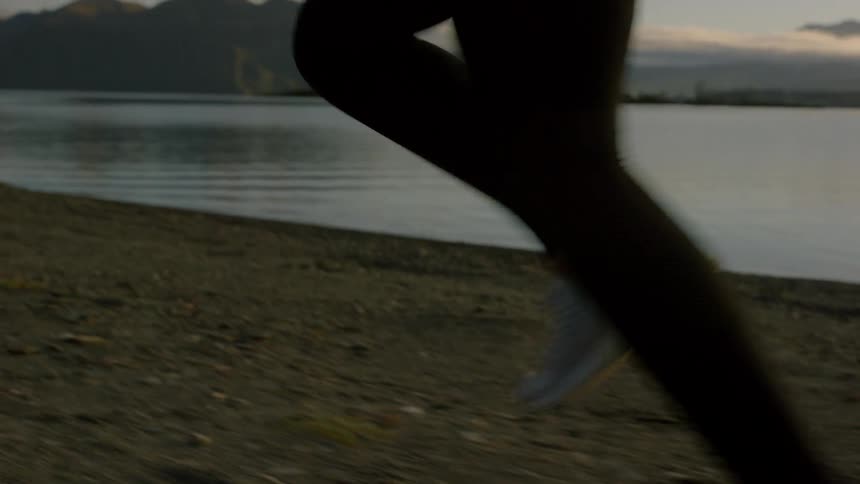 Person runs along a shoreline