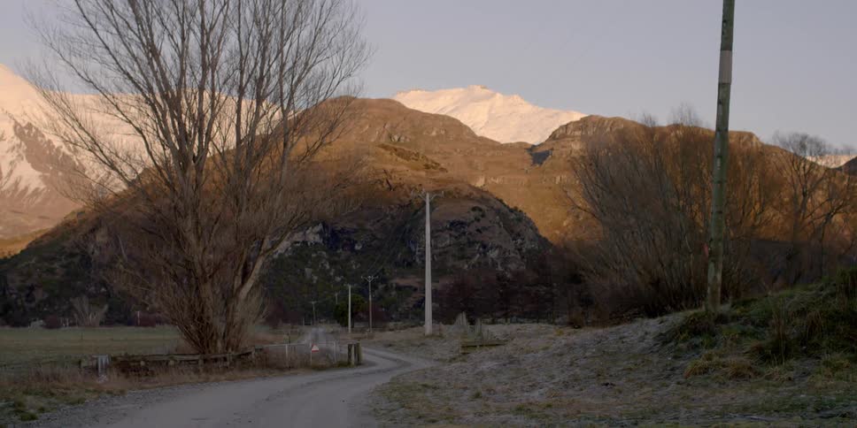 Path winding through grassy area to mountains