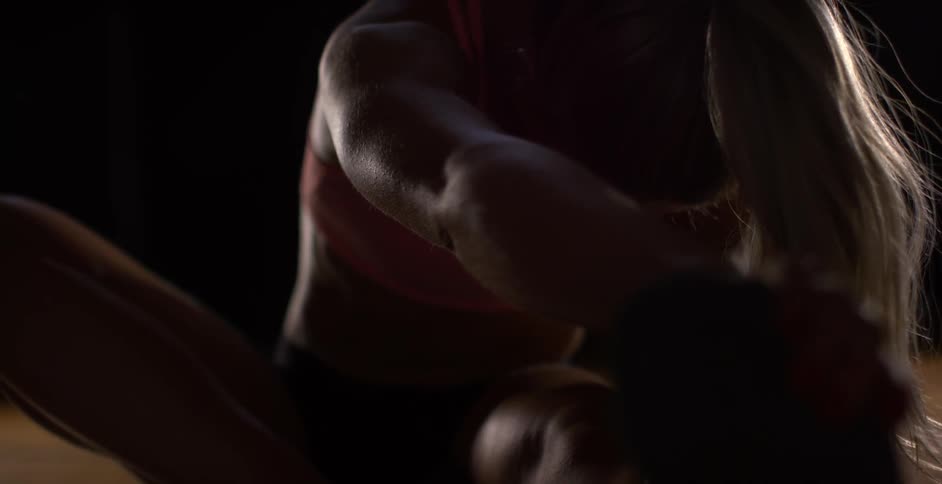 A woman is reaching forward in the dark