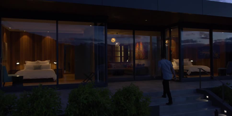 A man walks up the steps towards his house