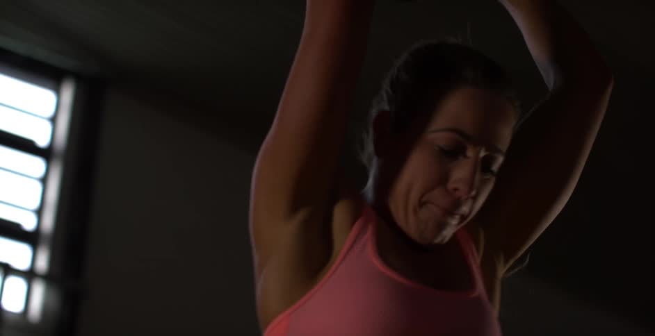A woman exercises using a ball