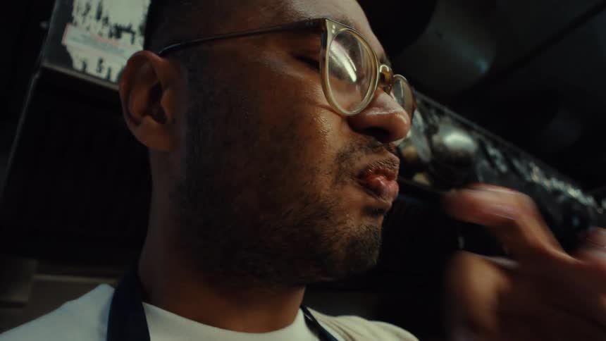 Close up slow motion shot of a professional chef tasting a delicious red sauce from his fingers in a commercial kitchen
