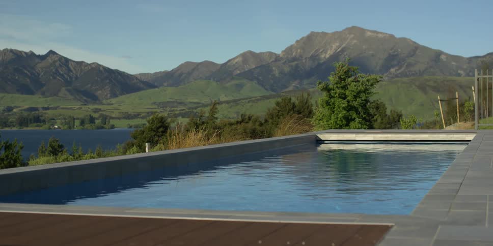 A private patio and pool overlooks trees and mountains
