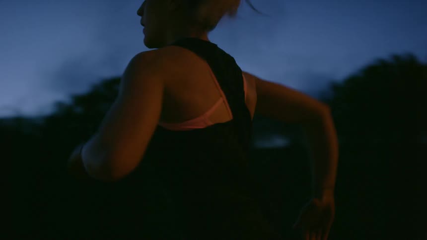 A woman running is wearing white sneakers