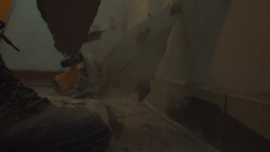 Debris and dust fall in slow motion during a messy demolition project