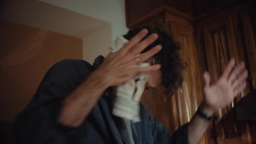 An overwhelmed father frantically tries to clean up a chaotic kitchen mess that he and his son made while cooking together