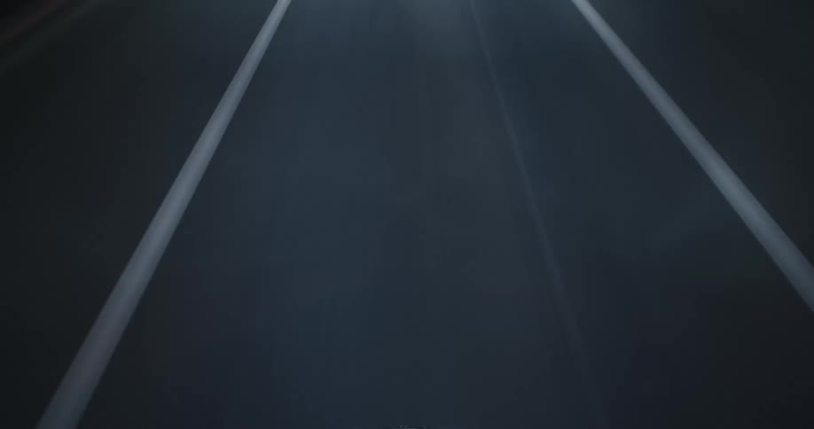 An abstract, high-speed point-of-view animation journeying through a VJ loop of flashing road lines and geometric patterns