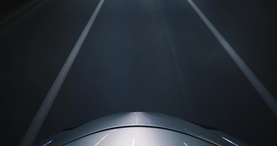 A mesmerizing point-of-view time-lapse from a car hood captures the abstract beauty of speeding through a city tunnel at night
