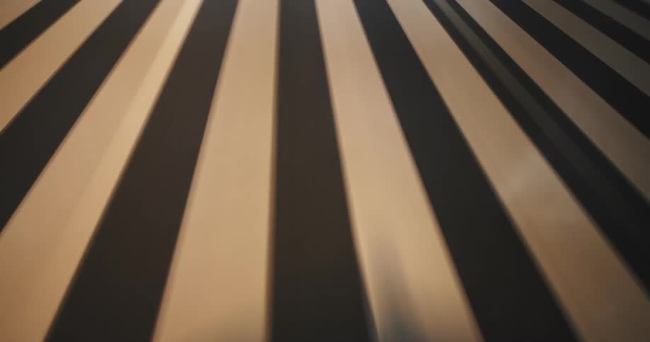 A frenetic, low-angle time-lapse of highway road lines blurring past at high speed during a nighttime drive