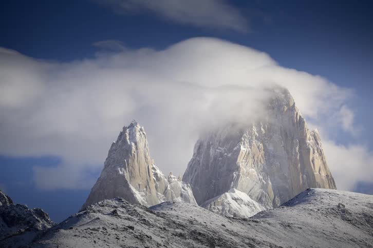 Time-lapse of dramatic clouds swirling around the majestic, snow-capped peaks of Mount Fitz Roy in Patagonia