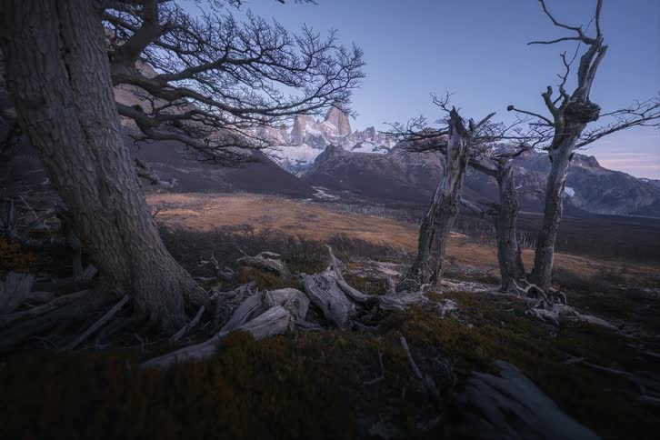 A dramatic time-lapse follows the transition from dusk to a beautiful sunrise over the majestic, snow-capped Mount Fitz Roy in Patagonia