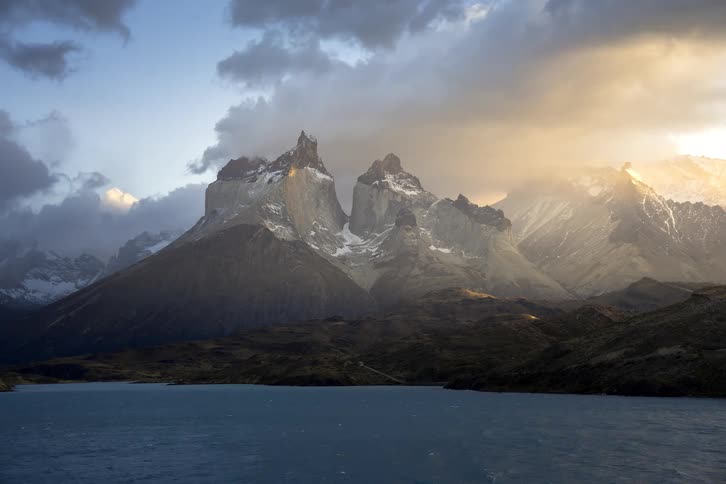 A dramatic time-lapse of clouds moving over the stunning Cuernos del Paine mountains at sunrise in Torres del Paine National Park, Patagonia