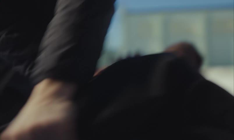 A chaotic first-person view of a violent struggle, with hands grabbing and pulling during an intense physical fight