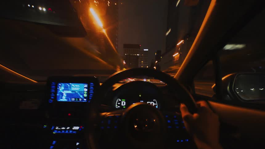 A first-person point-of-view timelapse of driving a car through tunnels and city streets at night, with light trails streaking across the screen