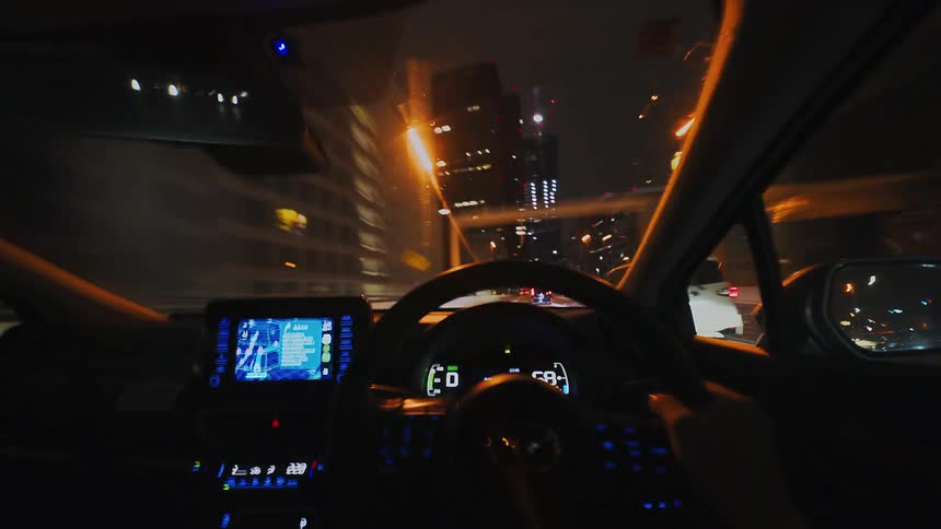 A thrilling first-person perspective timelapse shows a car speeding through the glowing highways and tunnels of a modern city at night