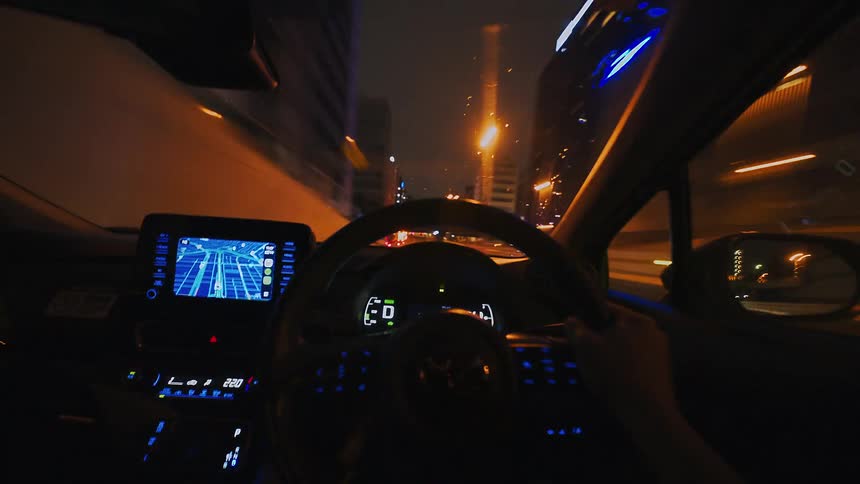 A mesmerizing first-person point-of-view time-lapse of driving through the illuminated streets and tunnels of a city at night
