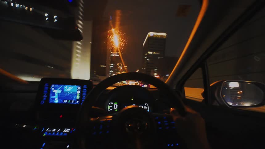 POV timelapse captures a rapid drive through a brightly lit tunnel and onto the streets of a bustling city at night