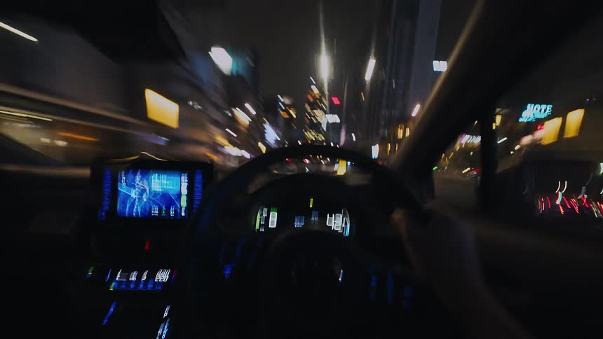 A driver's point of view hyperlapse driving through a bustling city at night, with light trails creating a sense of speed