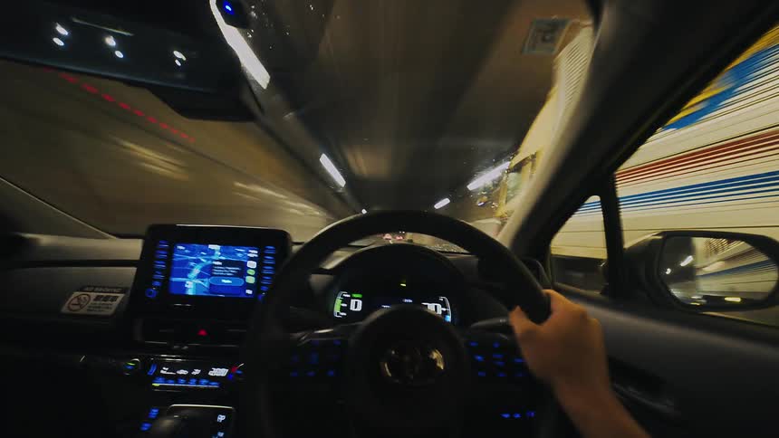 First-person POV time-lapse captures the fast-paced experience of driving through a brightly lit city tunnel at night
