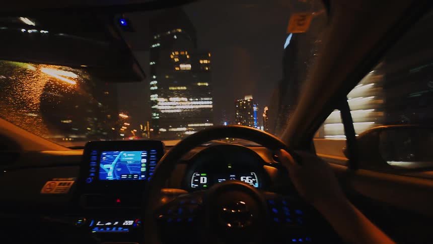 A thrilling first-person time-lapse of a car driving through the glowing streets and tunnels of a major city at night