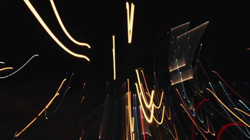 A mesmerizing, abstract time-lapse captures the frantic energy of a city at night through chaotic streaks of colorful light
