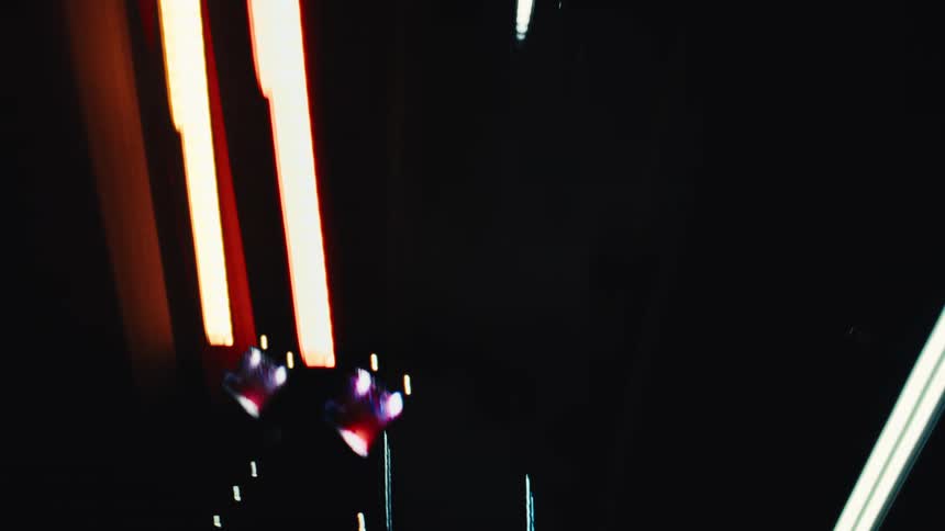 A chaotic kaleidoscope of neon light streaks and abstract patterns created by moving traffic at night