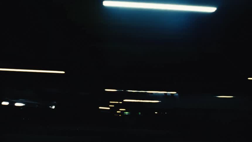 Abstract streaks of colorful city lights create a dynamic motion blur while driving at night