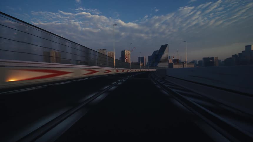 A fast-paced, motion-blurred point-of-view drive across Tokyo's Rainbow Bridge and elevated highway into the city at sunrise