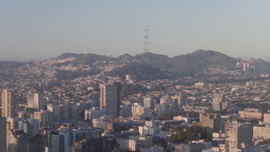 An expansive aerial view of the San Francisco cityscape with the Sutro Tower rising above the distant hills