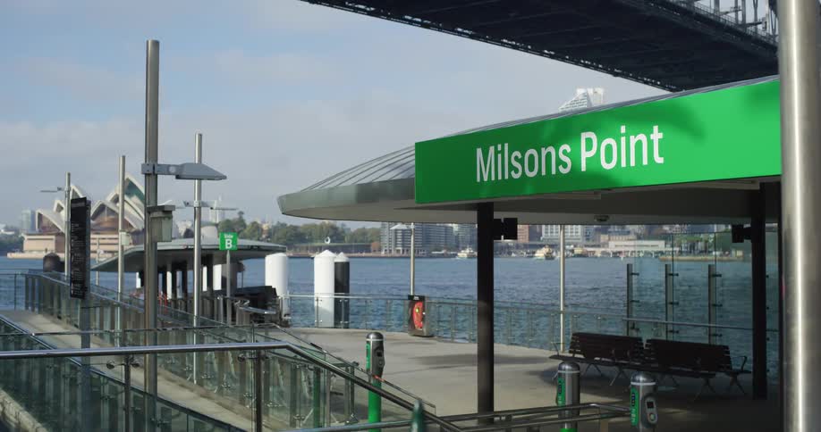 A tranquil view from the Milsons Point ferry terminal in Sydney, Australia, looking across the water towards the iconic Opera House and city skyline