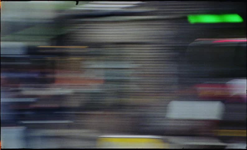 High-speed motion blur of city traffic and lights creates an abstract, energetic visual