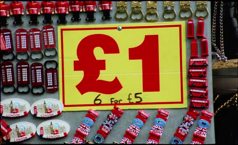 A shaky, handheld film shot zooms in and out on a one-pound price tag at a London souvenir stand