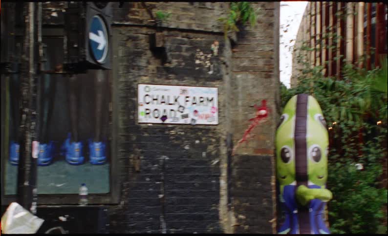 Close-up handheld view of the iconic 'Chalk Farm Road' street sign in Camden, London
