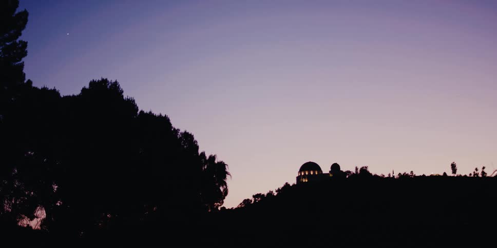 A still shot of the Griffith Observatory silhouetted against a beautiful purple and pink twilight sky