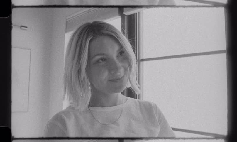 A loving couple shares a tender moment as they prepare for their baby's arrival in a vintage, black and white style home movie