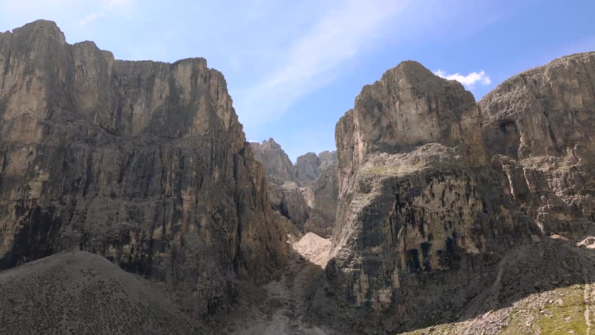 A breathtaking view of a rugged canyon pass in a high alpine mountain range on a clear sunny day