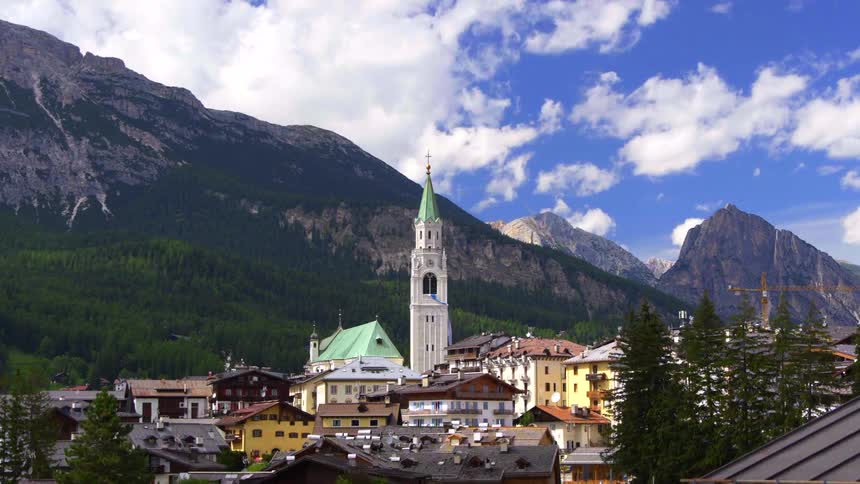 A sunny timelapse of the picturesque alpine town of Cortina d'Ampezzo, nestled in the Dolomites with clouds passing overhead