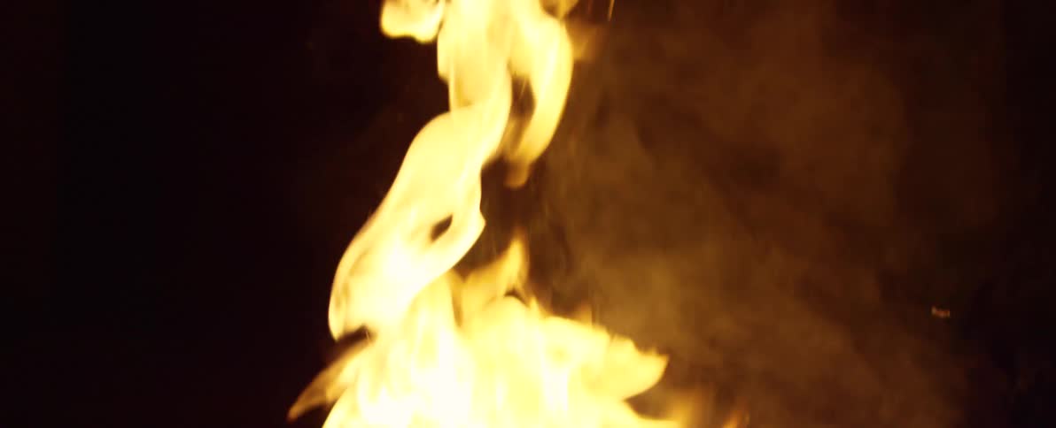 Vibrant flames dance and flicker in mesmerizing slow motion on a dark night