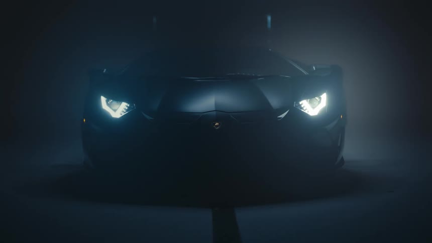 The bright headlights of a sleek black supercar illuminate a dark, smoke-filled garage