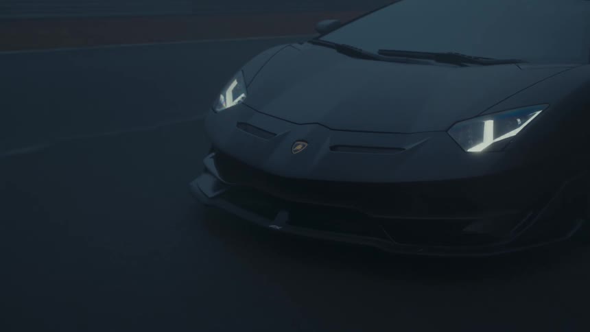 A sleek black supercar drives slowly along a winding racetrack, its headlights piercing through the thick, moody fog