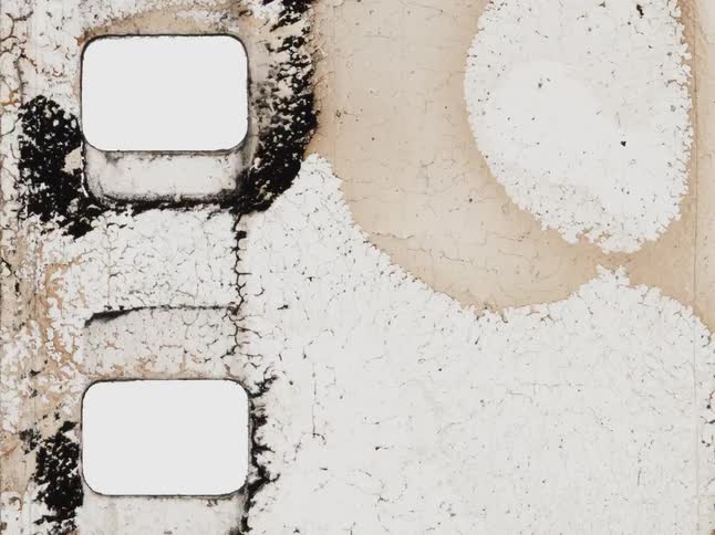 A close-up view of a deteriorating old film strip animates with grungy textures and abstract patterns